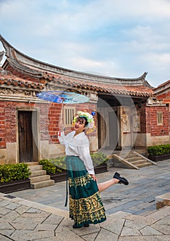 Portrait of asian woman wearing a floral crown and an ancient horse faced skirt