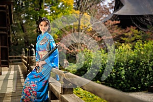 Portrait of asian woman wearing japanese blue kimono and umbrella on holding hand