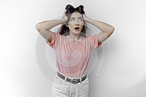 A portrait of an Asian woman wearing a pink t-shirt isolated by white background looks depressed