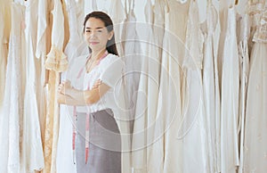 Portrait of asian woman wedding dress store owner standing and cross arm,Beautiful dressmaker in shop and small business,Happy and