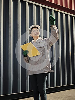 Portrait of asian woman worker holding clipboard and pointing