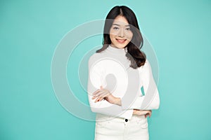 Portrait of Asian women with arms crossed and smile isolate green background