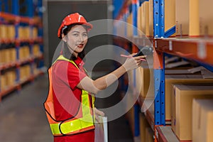 Portrait Asian worker warehouse stock control staff work checking inventory amount using bar code scanner