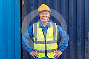 Portrait of Asian workers import and export goods wear a helmet logitics shipping at container background