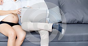 Portrait of a asian young couple husband and wife sitting on the sofa.