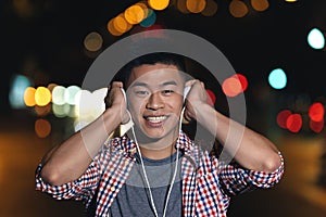 Portrait of a asian young man listening music.