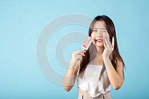 Portrait of Asian young woman with sensitive teeth after eating delicious ice cream