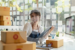 Portrait of Asian young woman SME working with a box at home the workplace.start-up small business owner, small business