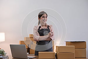 Portrait of Asian young woman SME working with a box at home the workplace.start-up small business owner, small business