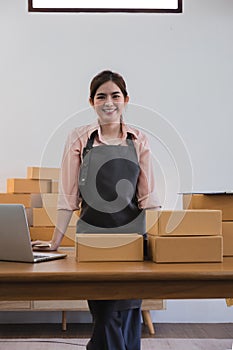 Portrait of Asian young woman SME working with a box at home the workplace.start-up small business owner, small business