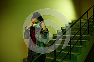 Portrait of an Asian young woman. stairwell of the hospital. the girl wears a mask to avoid getting infected with the virus