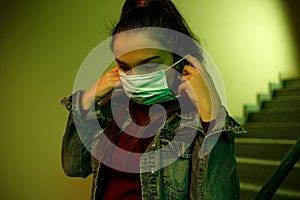 Portrait of an Asian young woman. stairwell of the hospital. the girl wears a mask to avoid getting infected with the virus