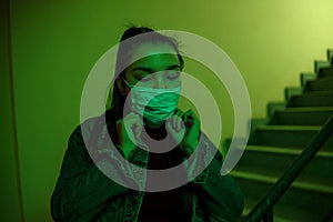 Portrait of an Asian young woman. stairwell of the hospital. the girl wears a mask to avoid getting infected with the virus
