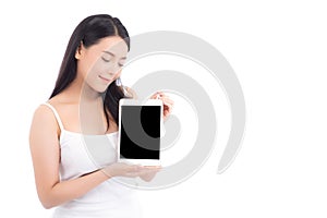 Portrait of asian young woman standing showing blank screen tablet isolated on white background