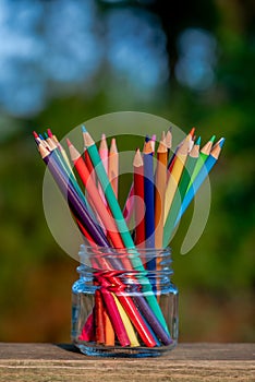 Portrait aspect of colorful pencils in glass jar