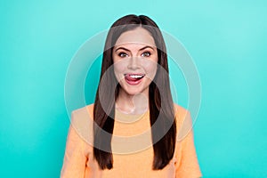 Portrait of astonished young lady tongue lick teeth beaming smile isolated on turquoise color background