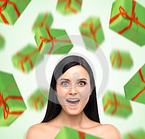 A portrait of astonishing woman who imagines green gift boxes.
