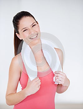 Portrait of athlete, gym or happy woman with towel for fitness or wellness with confidence. Smile, model laughing or