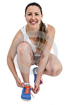 Portrait of athlete woman tying her running shoes