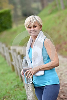 Portrait of athletic senior woman smiling after excercising