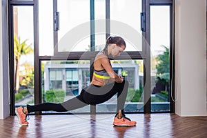 Portrait of an athletic woman doing exercising abdominals work-out lying in gym at luxury hotel at summer