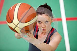 Portrait of an athletic woman playing basket-ball