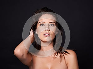 Portrait, attitude and woman in studio for skincare, wellness or collagen dermatology on black background. Beauty, face