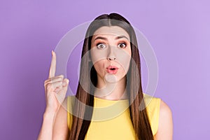 Portrait of attractive amazed brainy girl pointing forefinger up copy space isolated over violet purple pastel color