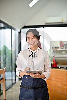 Portrait, Attractive Asian female coffee shop owner or waitress