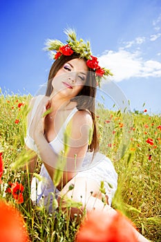 Portrait of an attractive beautiful girl in a poppy field