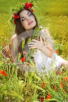 Portrait of an attractive beautiful girl in a poppy field