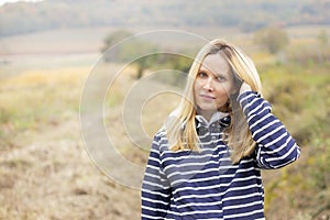 Portrait of attractive blonde woman on meadow