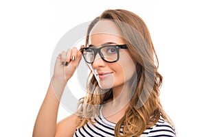 Portrait of attractive brainy young woman touching her glasses