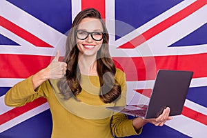 Portrait of attractive brown hair person hold netbook show thumb up  on british flag background