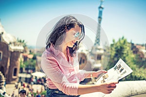 Portrait of attractive brunette girl looking at map while travelling