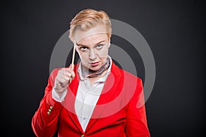 Portrait of attractive business woman holding pencil and thinkin