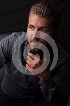 Portrait of an attractive man with a beard isolated on a black background