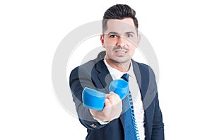 Portrait of attractive businessman holding retro telephone in hi