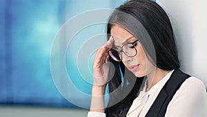 Portrait attractive businesswoman in glasses having headache on hitech exhibition