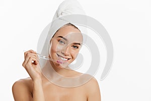 Portrait of attractive caucasian smiling woman isolated on white studio shot brushing her teeth