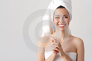 Portrait of attractive caucasian smiling woman isolated on white studio shot brushing her teeth
