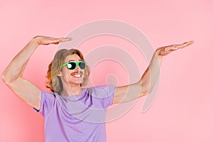 Portrait of attractive cheerful carefree guy dancing fooling having fun isolated on pink pastel color background