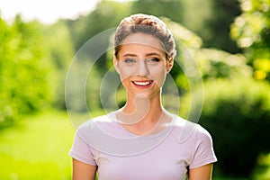 Portrait of attractive cheerful content brown-haired girl spending free time outside breathing fresh air outdoors