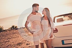 Portrait of attractive cheerful couple spending free time weekend getaway road trip adventure evening sunset outdoors