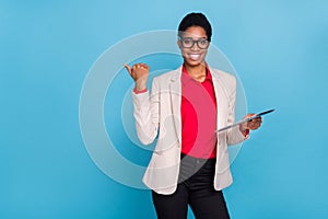 Portrait of attractive cheerful director financier using tablet showing copy space isolated over bright blue color