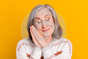 Portrait of attractive cheerful dreamy grey-haired woman resting sleeping fantasizing isolated over bright yellow color