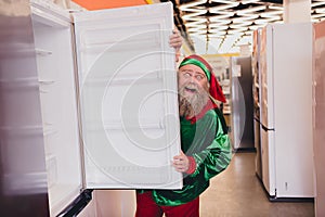 Portrait of attractive cheerful funky elf buying goods gift present newyear advent festal day at mall store indoors