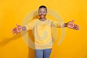 Portrait of attractive cheerful girl calling you come to me hugging isolated over bright yellow color background