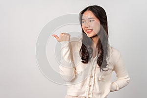 Portrait of attractive cheerful girl demonstrating and pointing finger to the side empty space isolated white background, showing