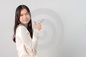 Portrait of attractive cheerful girl demonstrating and pointing finger to the side empty space isolated white background, showing